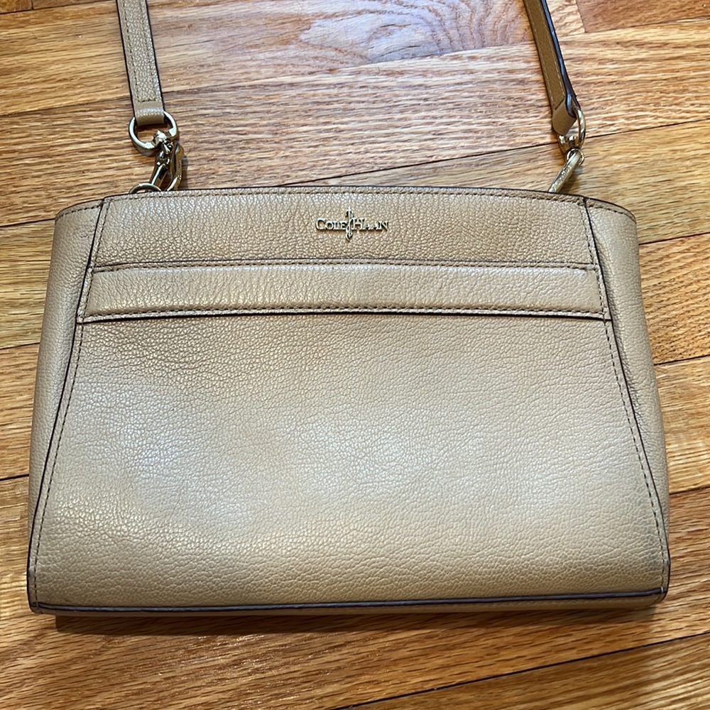 Cole Haan beige cross body bag with gold accents